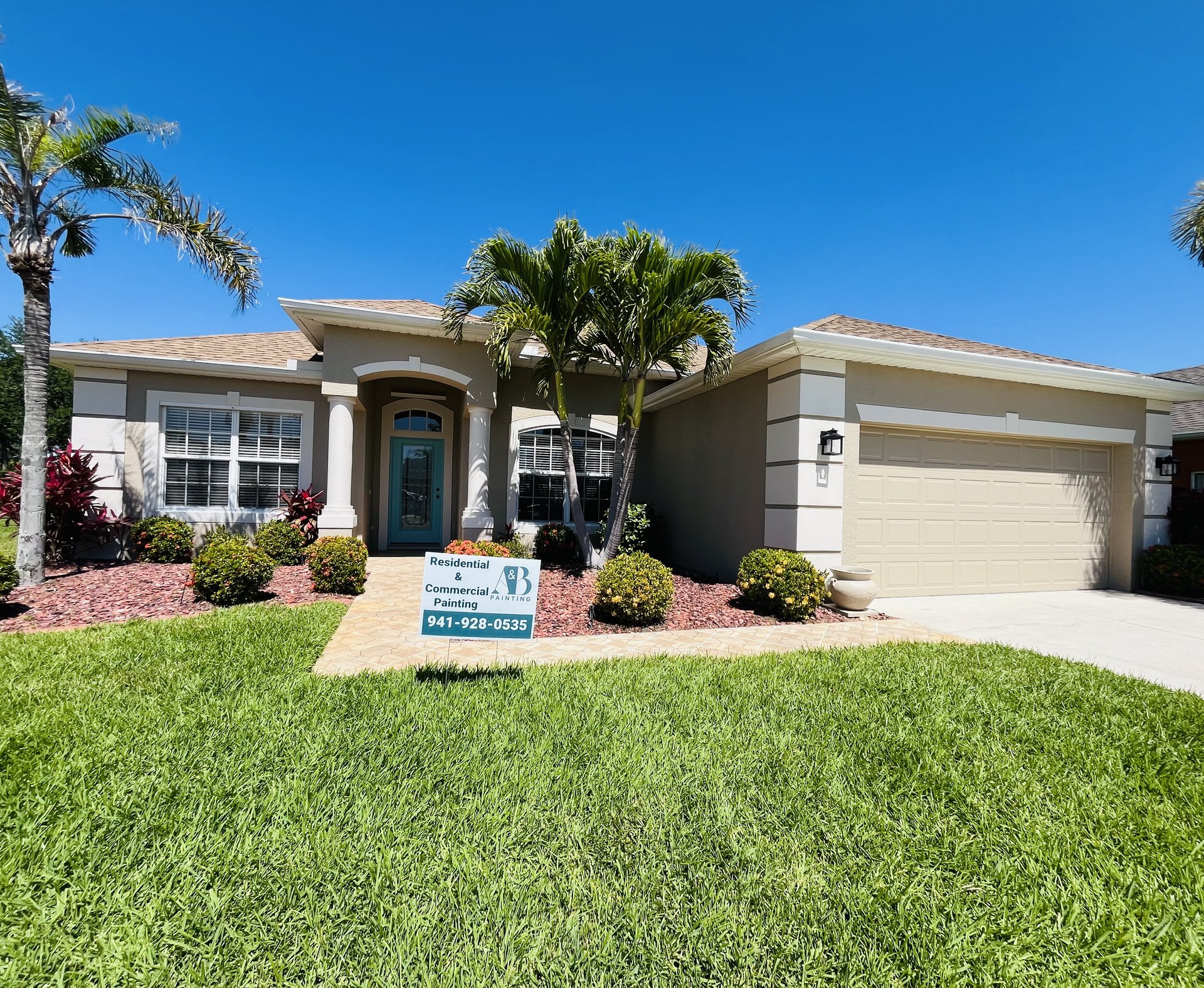 Port Charlotte home with freshly painted stucco exterior and arched entryway
