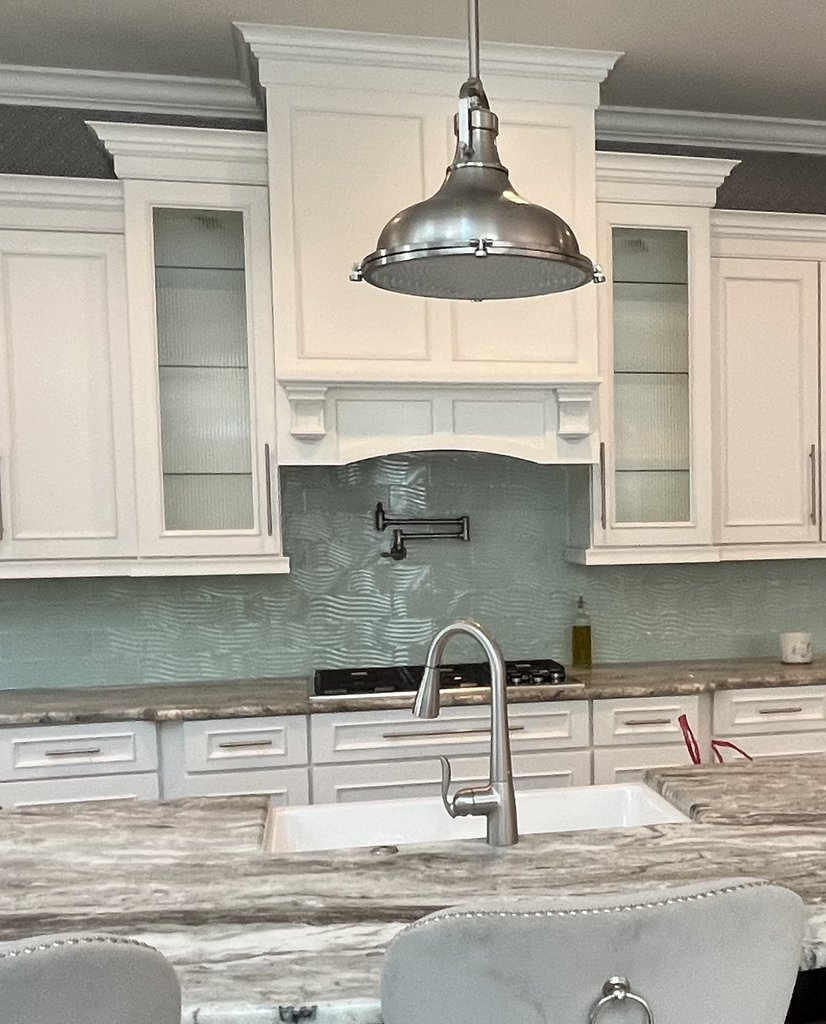 Refreshed kitchen with marble island and painted white cabinets